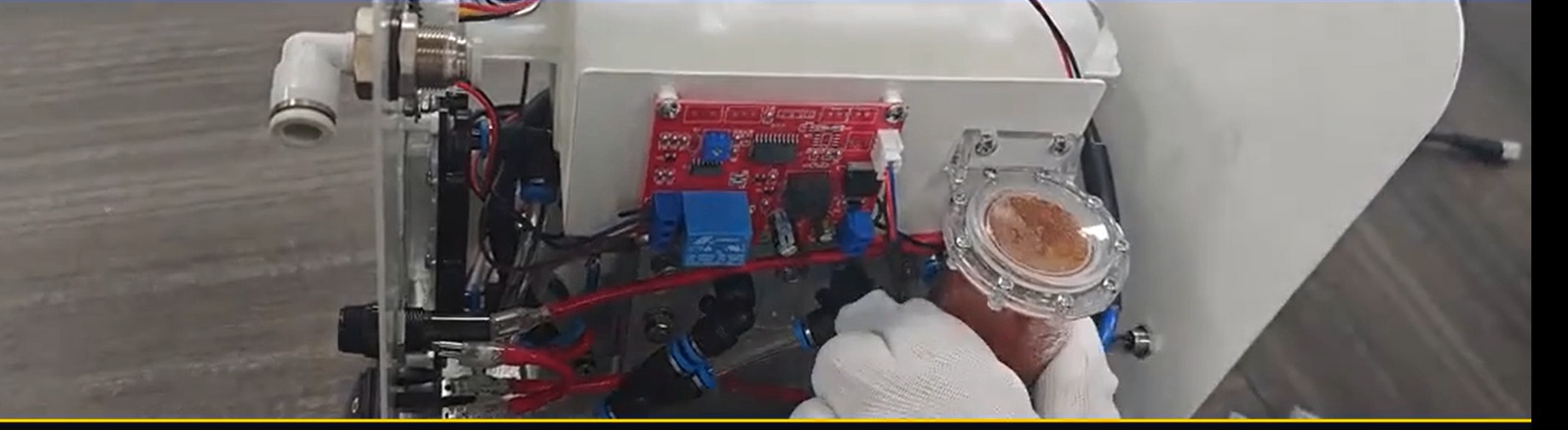 Technician removing the resin filter from the PEM unit enclosure